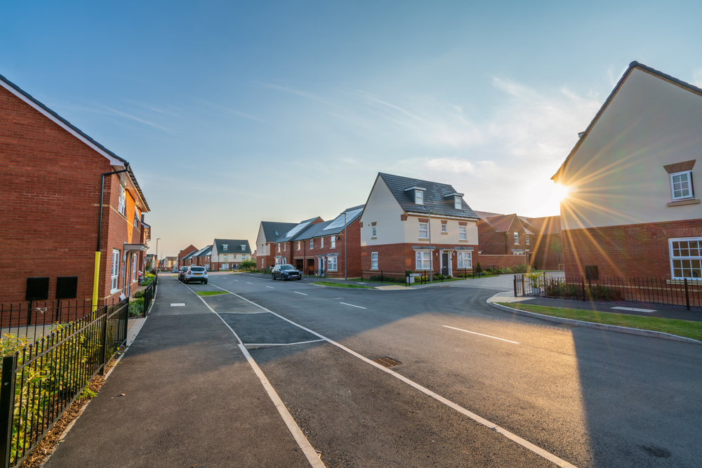 Sun showing between houses during a heatwave
