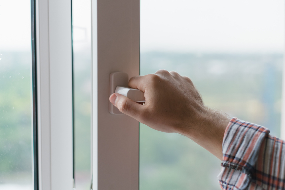 Person opening window during a heatwave