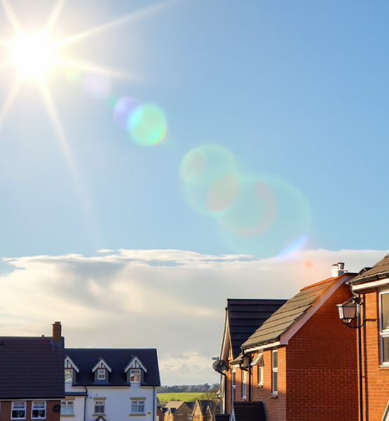 overheating in uk homes - sun flare over new build houses